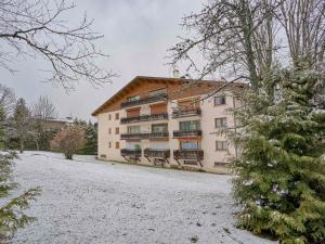 a large building with snow on the ground at Appartement rénové 4 pers. au centre de Megève - Balcon, parking, TV, Wifi - FR-1-453-66 in Megève +6 photos