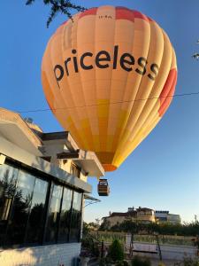 a large hot air balloon flying over a building at Cappadocia Villa Comfort in Nevşehir