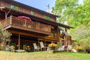 a large wooden house with a deck and chairs at Big Sky Cabin in Nashville