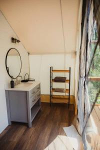 a bathroom with a sink and a mirror in a room at The Richbourg, Lux Safari Tent in Cadiz