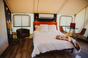 a bedroom with a large bed in a tent at The Richbourg, Lux Safari Tent in Cadiz