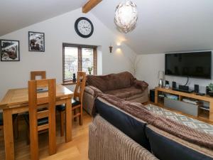a living room with a couch and a table at Low Fold Cottage in Penrith