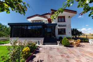 a house with a cat sitting in front of it at Cappadocia Villa Comfort in Nevşehir
