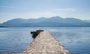 a boat on a dock in the middle of a lake at The Europe Hotel & Resort in Killarney