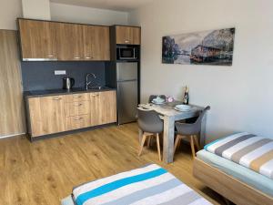 a small kitchen with a table in a room at JK Apartmány in Bělkovice