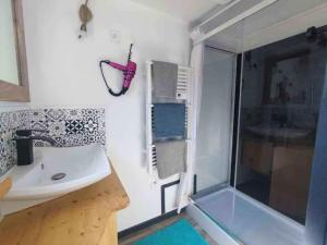 a bathroom with a sink and a shower at Le Clos des Passiflores in Pons +44 photos