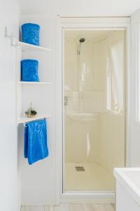 a bathroom with a shower and a glass door at LOCA BEACH in Taghazout