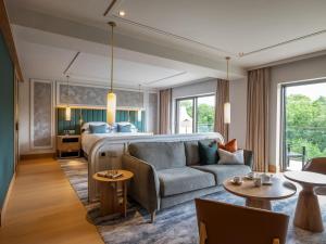 a hotel room with a bed and a couch at The Europe Hotel & Resort in Killarney