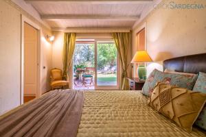 Ένα ή περισσότερα κρεβάτια σε δωμάτιο στο Alghero Villa Rujia with garden and pool