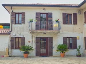 una casa con balcone e piante di fronte ad essa di Casa Veronika ad Arcade