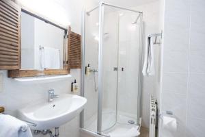 a bathroom with a sink and a shower at Heimat Natur Resort in Prägraten