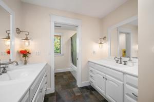 a white bathroom with two sinks and a mirror at Big Sky Cabin in Nashville +32 photos