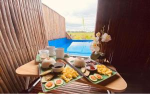 a table with two trays of food on it at Anelasplace Freshwater Resort in Calamundingan