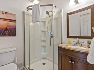 a bathroom with a shower and a toilet and a sink at Family fun on the lake! in Reeds Spring +36 photos