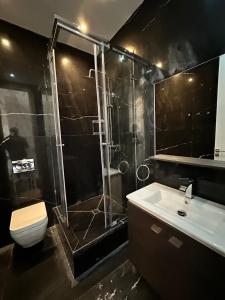 a bathroom with a shower and a toilet and a sink at Supérieur Suite Balima B25 in Rabat +55 photos