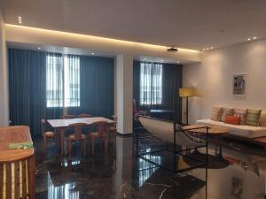a living room with a couch and a table at Supérieur Suite Balima B25 in Rabat