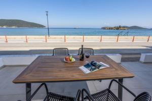 a wooden table with a bowl of fruit on it at Aurora suite in Nea Peramos