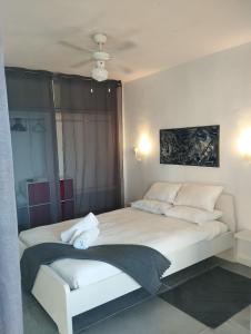 a bedroom with a large bed with white pillows at Sea View Calypso Condo in Mijas +30 photos