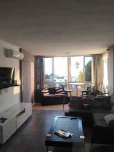 a living room with a couch and a table at Sea View Calypso Condo in Mijas