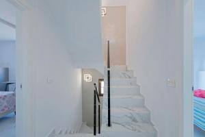 a staircase in a house with white walls at Adosado Sara en Fanabe in Adeje