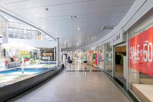 a shopping mall with people walking in the aisle at Adosado Sara en Fanabe in Adeje