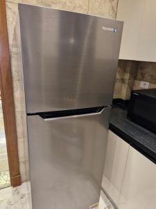 a stainless steel refrigerator in a kitchen at شقة غرفتين واحدة ماستر اثاث فندقي الرحاب القاهرة الجديدة in Cairo