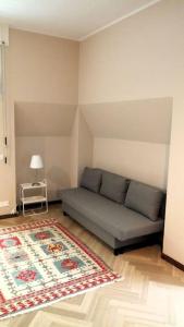 a living room with a couch and a rug at Ampio monolocale vicino al lungolago di Lecco in Lecco +45 photos