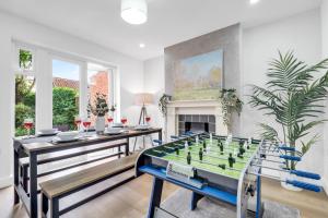a living room with a table and a foos ball at Inspira Stays - Spacious Modern House in Leicester - Free Parking - Xbox, Table Football & Smart TV in Braunstone