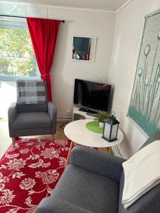 a living room with two chairs and a tv at Aurora Center 3 in Rovaniemi