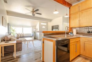 a kitchen and living room with a couch at Den Street Cottage in Los Alamos