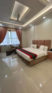 a bedroom with a large bed in a room at Nesto Hotel in Manāwirah +86 photos