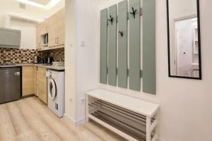 a kitchen with a washer and dryer at Eda Budapest Apartment in Budapest +3 photos