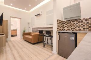 a kitchen and living room with a couch and a table at Eda Budapest Apartment in Budapest