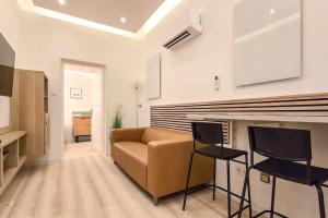a living room with a couch and two chairs at Eda Budapest Apartment in Budapest