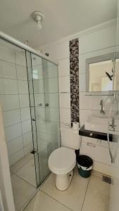 a bathroom with a toilet and a shower and a sink at GRAN HOTEL in Três Lagoas