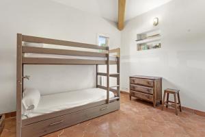 une chambre avec un lit superposé et une table en bois dans l'établissement Villa familiale la Croix-du-Sud, à La Croix-Valmer