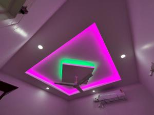 a purple room with a purple ceiling with a tv at Puzhayoram Homestay in Trichūr