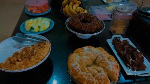 a table topped with different types of pastries and fruit at GRAN HOTEL in Três Lagoas +9 photos