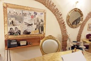 a room with a mirror and a phone on a wall at Blao boutique hotel in Oristano