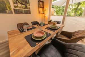 a dining room table with plates and glasses on it at Villa Verde - Nordhorn in Nordhorn