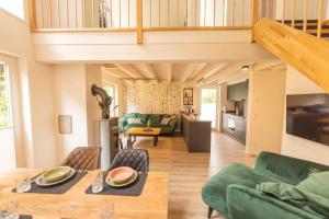 a living room with a couch and a table at Villa Verde - Nordhorn in Nordhorn