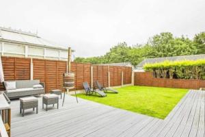 a backyard with a wooden deck with a lawn at Entire house - Peaceful 3 bedroom home in Rishton