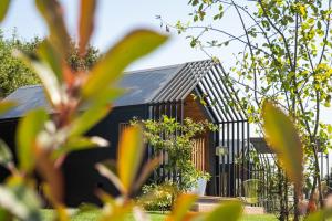 a black house with a black roof at Bruval Eco Retreat in Sandim