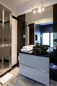 a bathroom with a sink and a glass shower at Amber Suite Szczecin hotel na Starym Mieście Adults Only in Szczecin