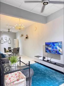 a living room with a couch and a tv at M & V butterworth in Butterworth