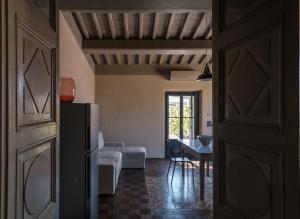 a kitchen and living room with a refrigerator and a table at Podere San Pasquale - La Vigna in Castiglione dʼOrcia