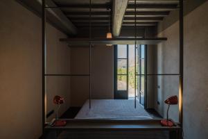 a bed in a room with two lamps at Podere San Pasquale - La Vigna in Castiglione dʼOrcia