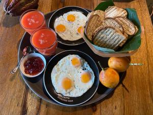 three plates of eggs and bread on a table at Amaca Eco Station in Iquitos