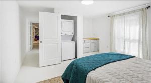 a white bedroom with a bed and a refrigerator at Historic New Orleans in the Treme in New Orleans