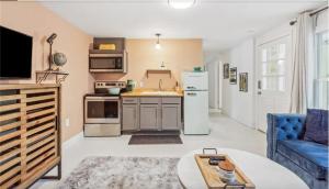 a kitchen with a refrigerator and a table at Historic New Orleans in the Treme in New Orleans